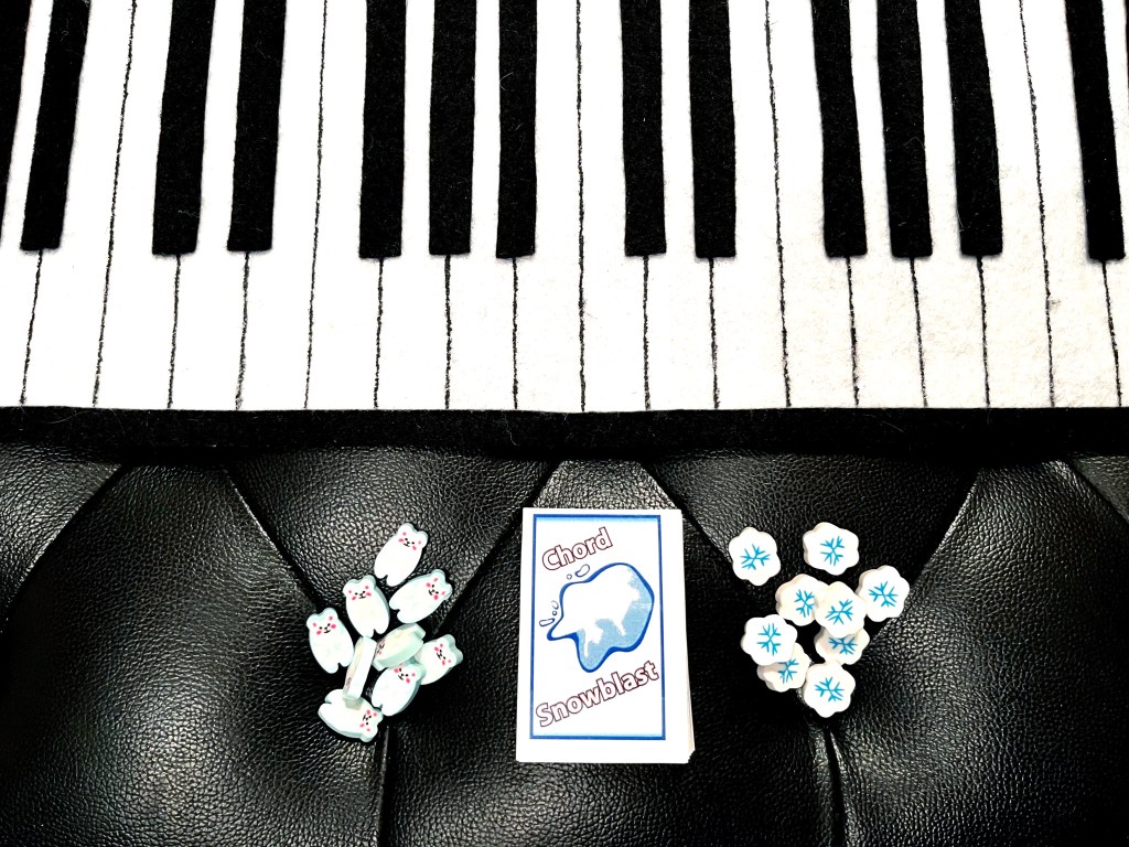 piano keyboard snow snowball card stack about music chords with snowflake and polar bear erasers game markers