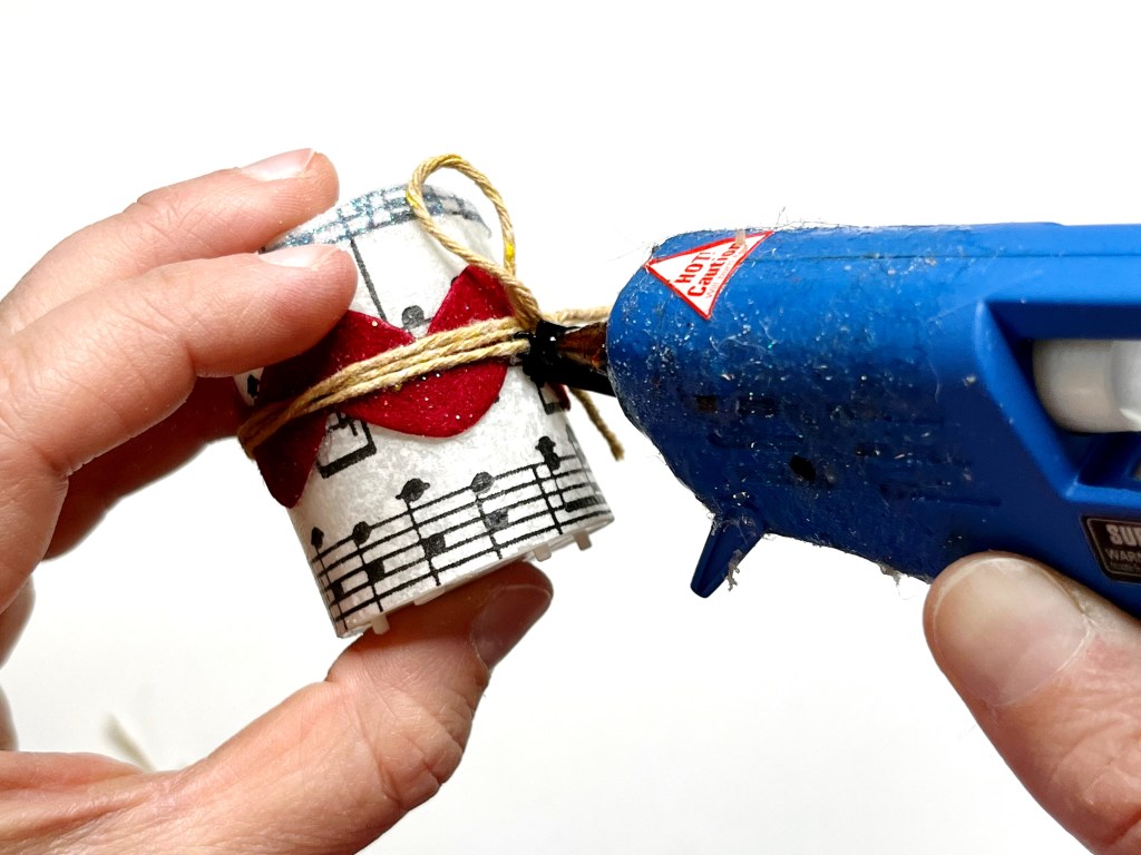 Apply hot glue to the back of the keyboard charm to help hold it in place.