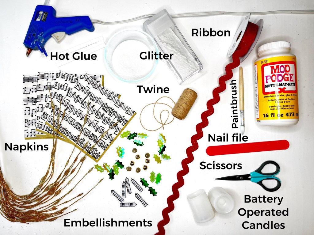 Picture of tools and supplies needed to complete the craft. Tools required are hot glue gun and glue, Mod Podge waterbased sealer and glue, paintbrush, scissors, bowl, and nail file. Supplies needed are battery-operated candles, music note napkins, glitter, twine and your choice of embellishments (such as ribbon, keyboard charm, jingle bells, and sequin holly leaves).