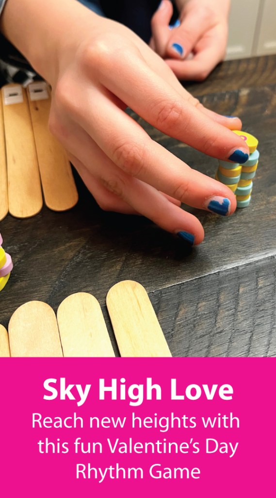 Piano student places heart erasers one on top of the other to form a tower of erasers. The student is playing Sky High Love, a Valentine's day rhythm game.