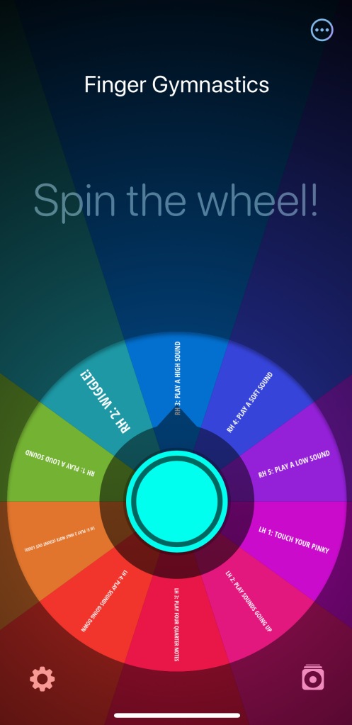 A rainbow colored wheel of fortune sits under the words Spin the wheel! The name of the wheel is Finger Gymnastics.