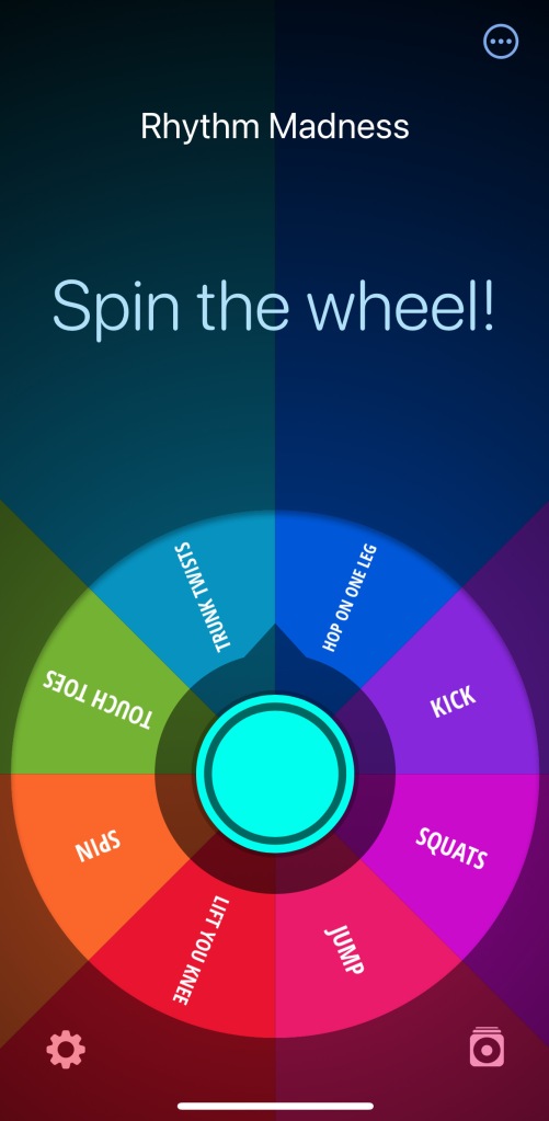 A rainbow colored wheel of fortune sits under the words Spin the wheel! The name of the wheel is Rhythm Madness.