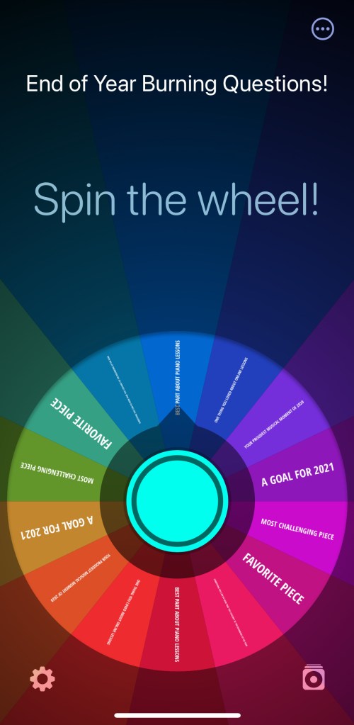A rainbow colored wheel of fortune sits under the words Spin the wheel! The name of the wheel is End of Year Burning Questions.