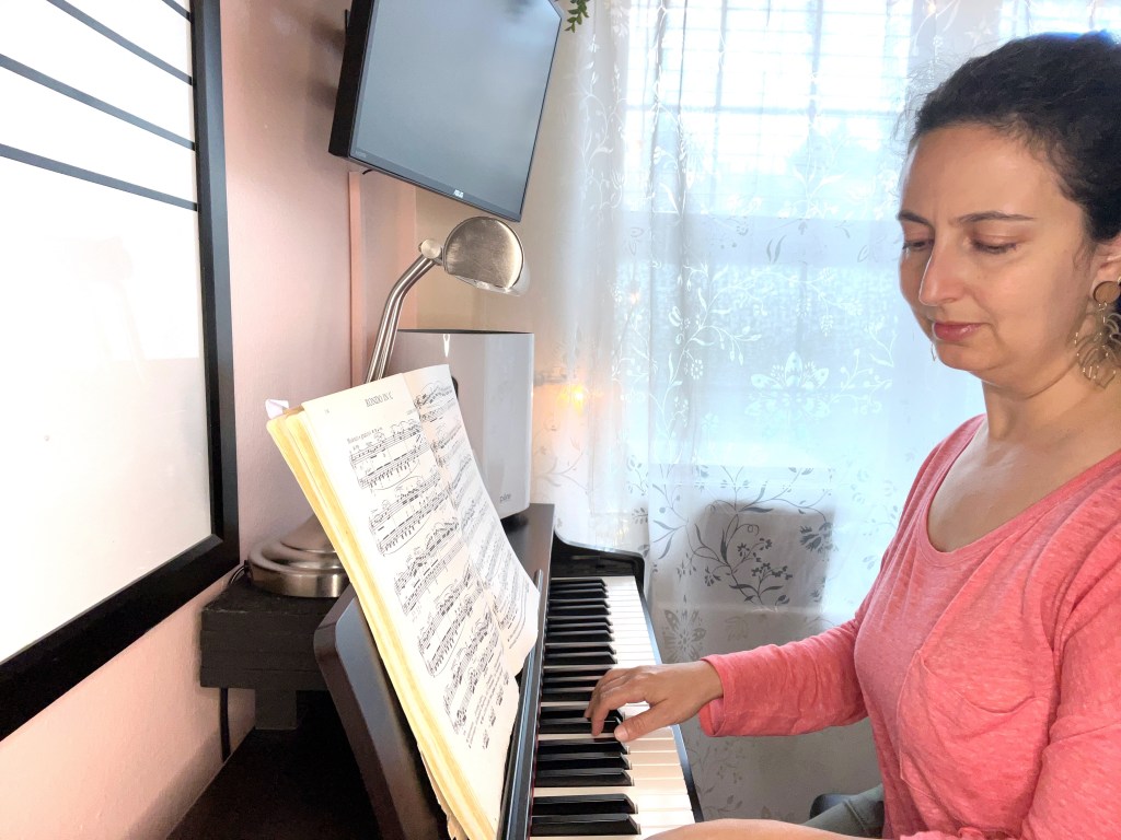 Pianist plays a piece by Beethoven while looking down at the keyboard.