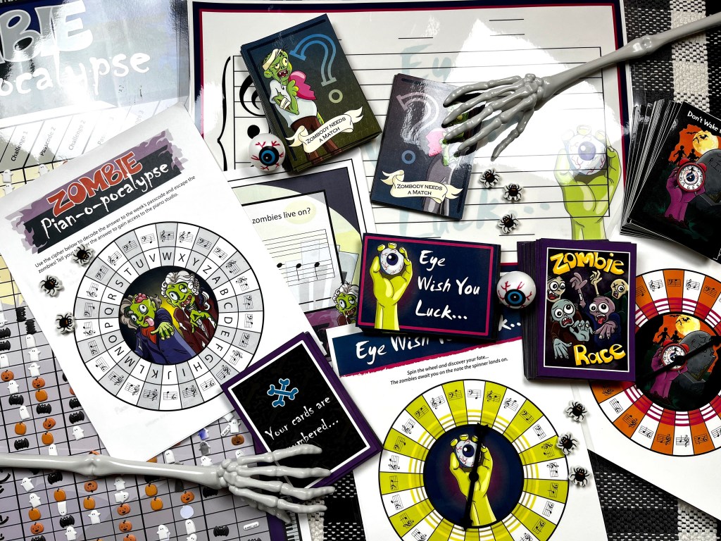 All the games and activities from the zombie piano apocalypse are laying on a table with skeleton hands reaching out to play the games.