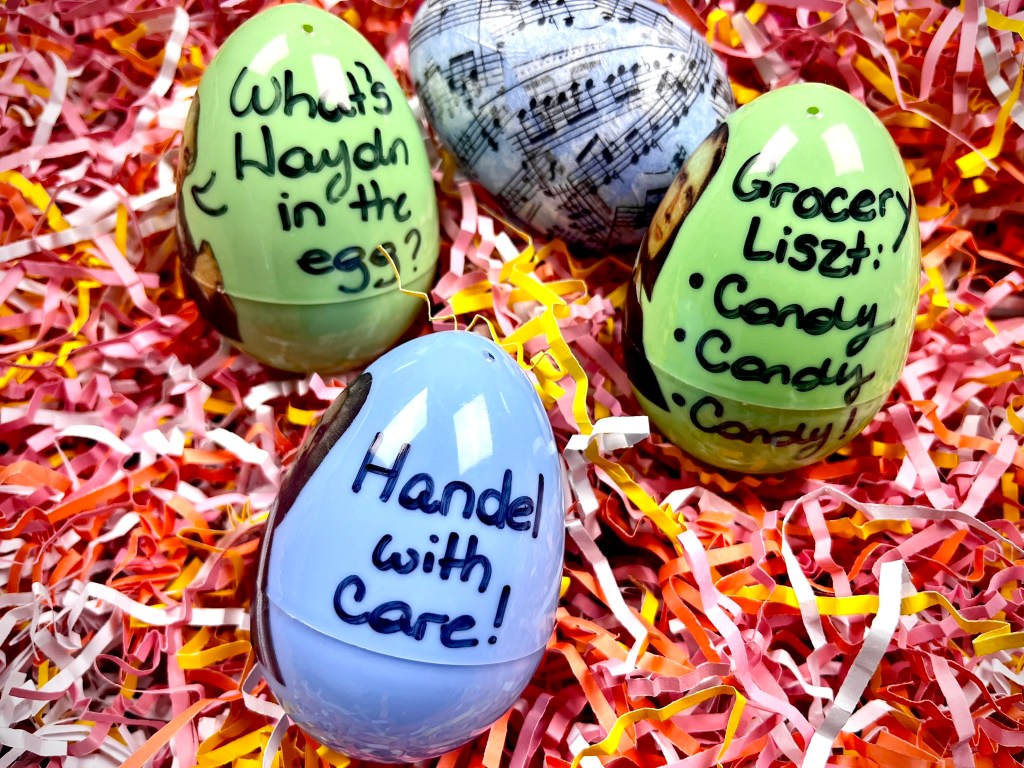 Classical music pun on plastic easter eggs sit in a pile of pink grass.