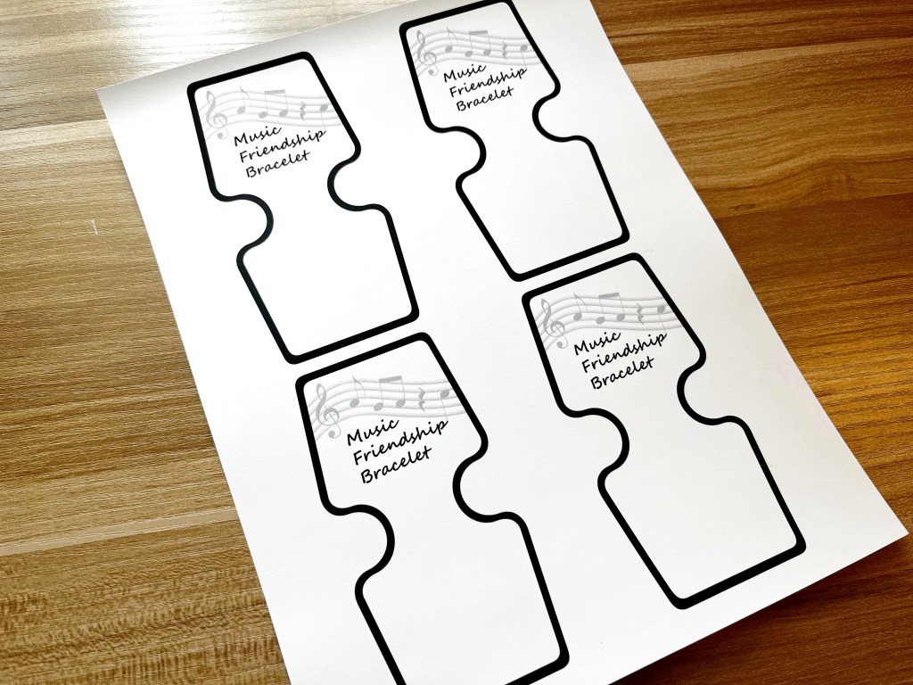 Four music bracelet display cards printed on a sheet of white cardstock.