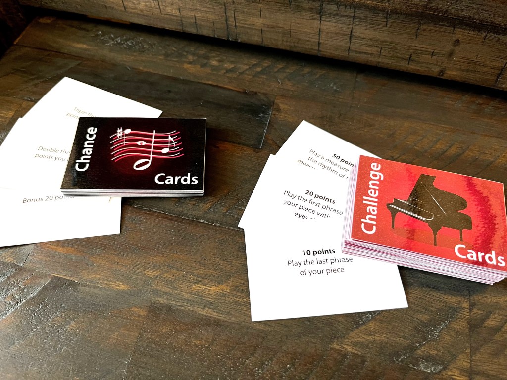 Challenge and chance cards sit on a dark wood table