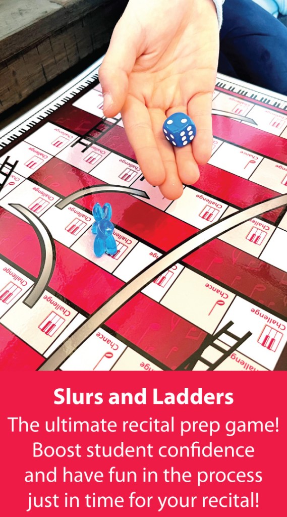 A piano student rolls a blue onto the gameboard as they play Slurs and Ladders, the Recital prep game.
