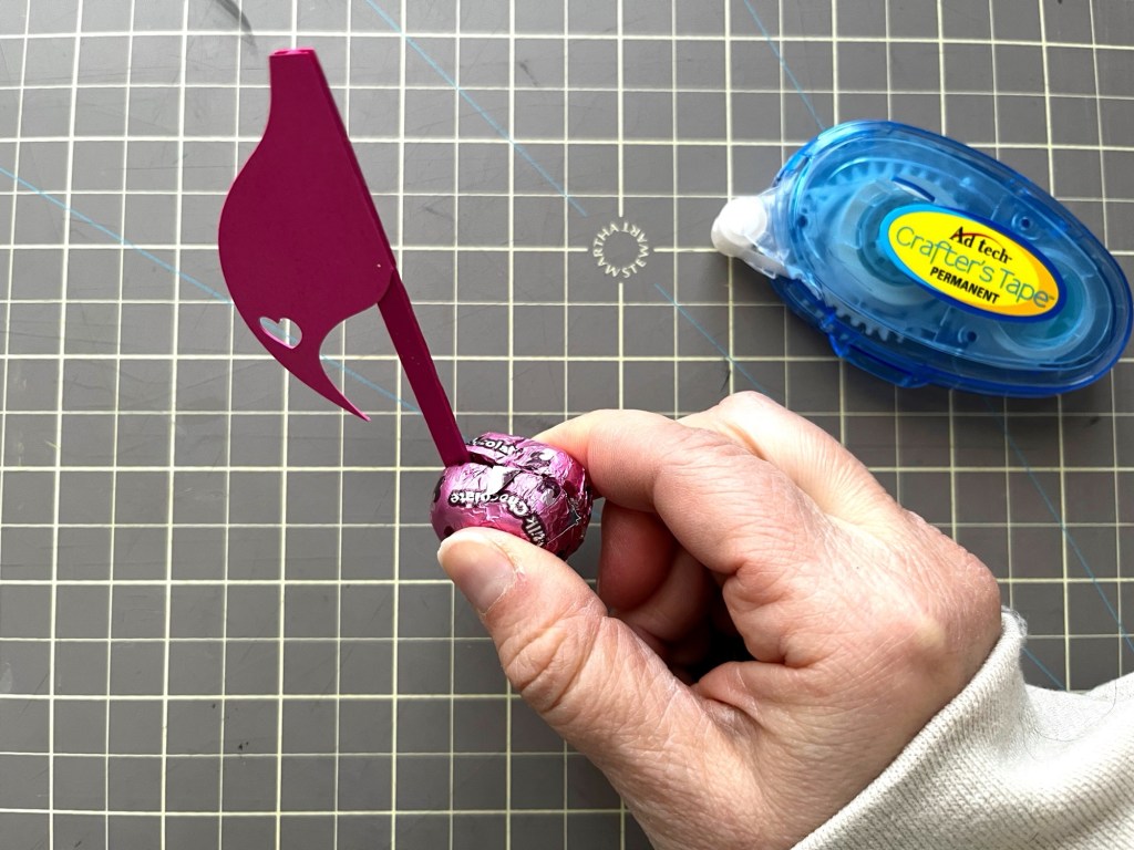 The crafter presses the other chocolate onto the double sided tape