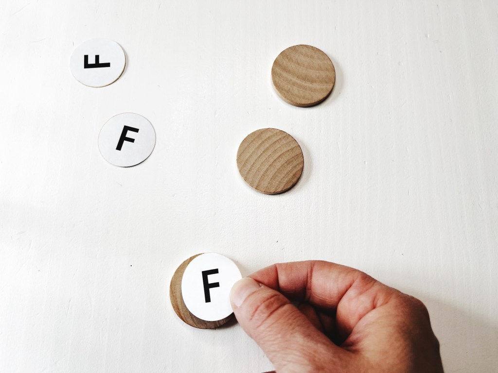 The label with the pitch name is glued to a wood coin.