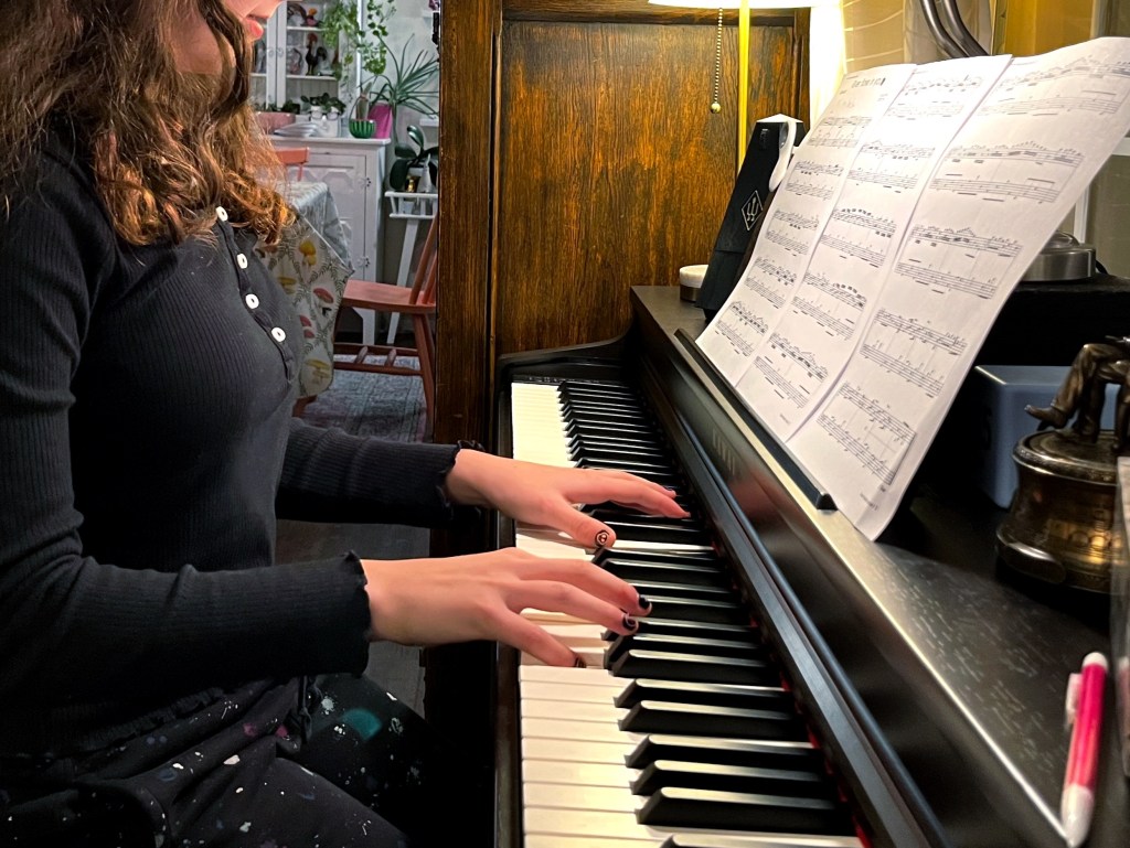 A piano student practices the piano.