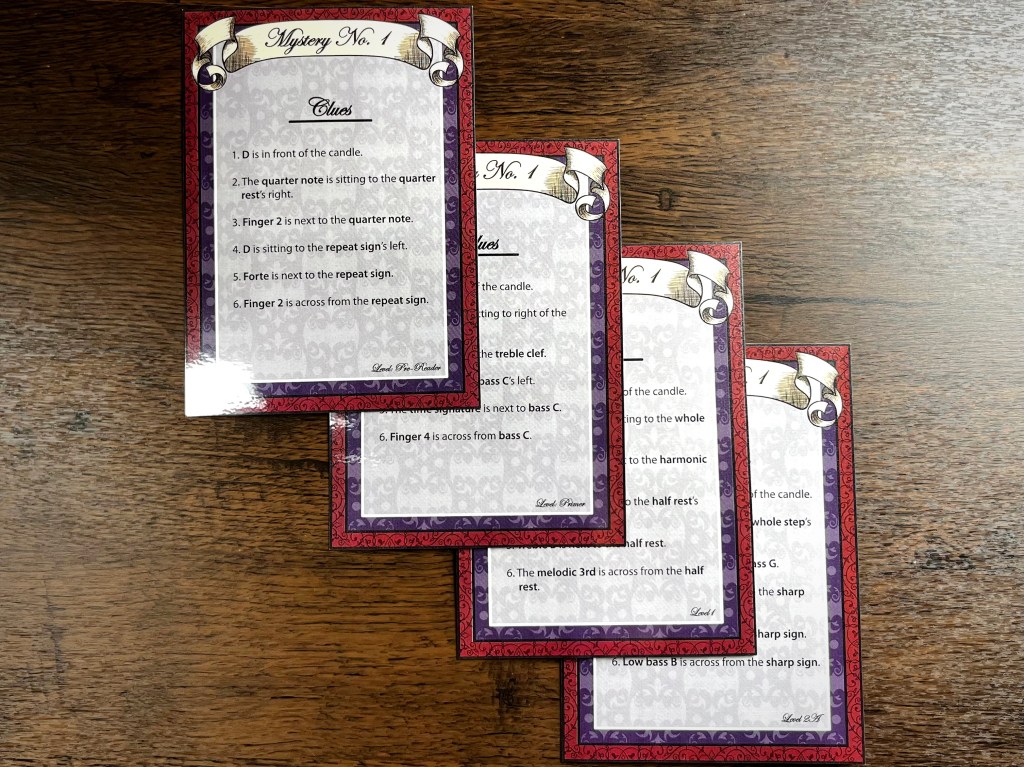 A close-up view of four colorful clue cards from the 'Composer Mysteries' game, featuring music theory clues.