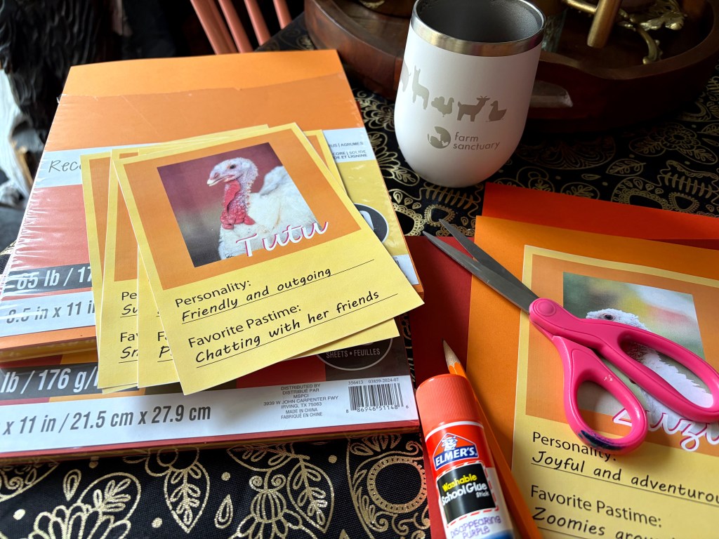 Colorful craft materials including orange cardstock, scissors, and glue, with printed cards featuring a turkey named Tutu showcasing personality traits and pastimes.