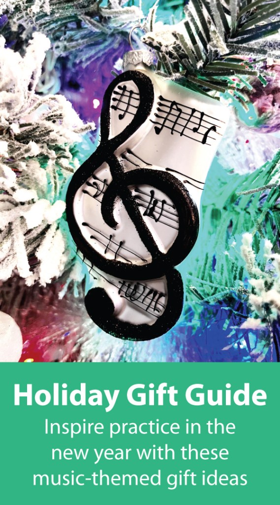 A colorful holiday ornament shaped like a treble clef with musical notes, hanging on a snowy tree with a vibrant background and a caption promoting a holiday gift guide for music-themed gift ideas.